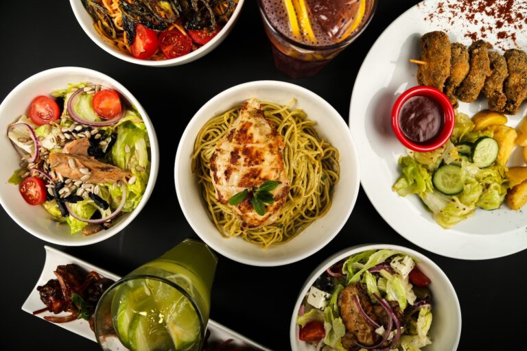 A variety of delicious salads and pasta dishes arranged beautifully.